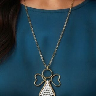 Gold-tone chain necklace with an ang el-shaped pendant featuring a beaded white dress, worn over a teal top.